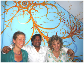 Leora Sharone, Vikas Trapathi, and Ruth Sharone in front of the mural Leora painted for the Bhadri Kali Guest House.