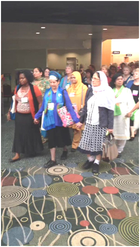 Despina Namwembe, Elana Rozenman, and Siham Halabi lead the Multi-faith Women’s Walk for Peace at the Parliament of the World’s Religions last October. – Photo: Twitter, Paul Rauschenbush