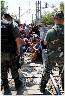 Migrants being stopped at the Greek–Macedonian border near Gevgelija by the Macedonian Police, 24 August 2015. Photo: Wikiped