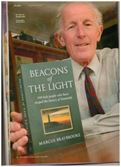 Marcus Braybrooke holds up his Beacons of the Light, recently republished. It provides short but rich biographies of 100 “holy people” who over the centuries have influenced world religion. – Photo: Amazon