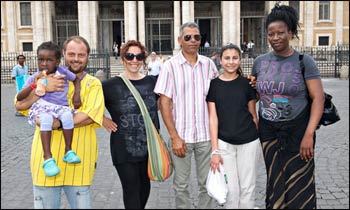 Luca Bonucci, left, holding child, and some of the homeless people who have moved into the church of Saint Mary Major, Rome. – Photograph: Chris Warde-Jones