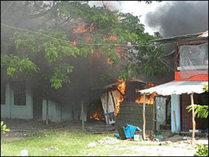 Homes being burned in the 2012 rioting between majority Buddhists and minority Muslims in western Myanmar. – Photo: Wikipedia
