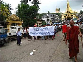 Saffron Revolution protestors in Yangon carrying a banner that reads “Non-Violence: National Movement” in 2007 – Photo: Wikipedia