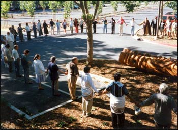 Those attending a 1997 planning conference for United Religions Initiative gathered for a circle of blessings as they began work, blessings said around a beautiful whale carved from a massive Alaskan cedar, felled nearly a century ago. – Photo: Don Frew
