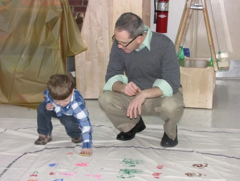 David Joyal and his son, Aidan, stamp patterns on the path of a labyrinth as part of an intergenerational project. Photo: Sharon Sheridan