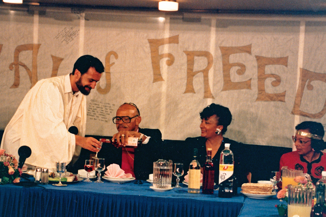 Distinguished interfaith activist Rabbi David Rosen receives wine from a Christian pastor at a Seder 24 years ago – Photo: Ruth Sharone