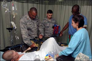Military chaplains and medical staff take hands in prayer in Iraq. Photo: Wikimedia