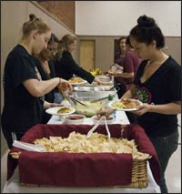 Juniors Tiffany Koval and Daisy Aldana enjoy a free dinner at the Church of the Brethren on Tuesday.Photo by Denisse Leung