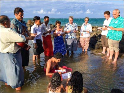 From the December 2014 story by Aaron Stauffer: People gather to pray in the sea to express solidarity with communities affected by sea-level rise . – Photo: Twitter/OurVoices2015