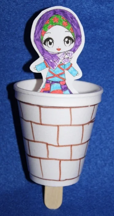 Sample craft made in our Lower Elementary class. The craft stick can be moved up and down as though the woman were going in and out of the well – Photo: VG