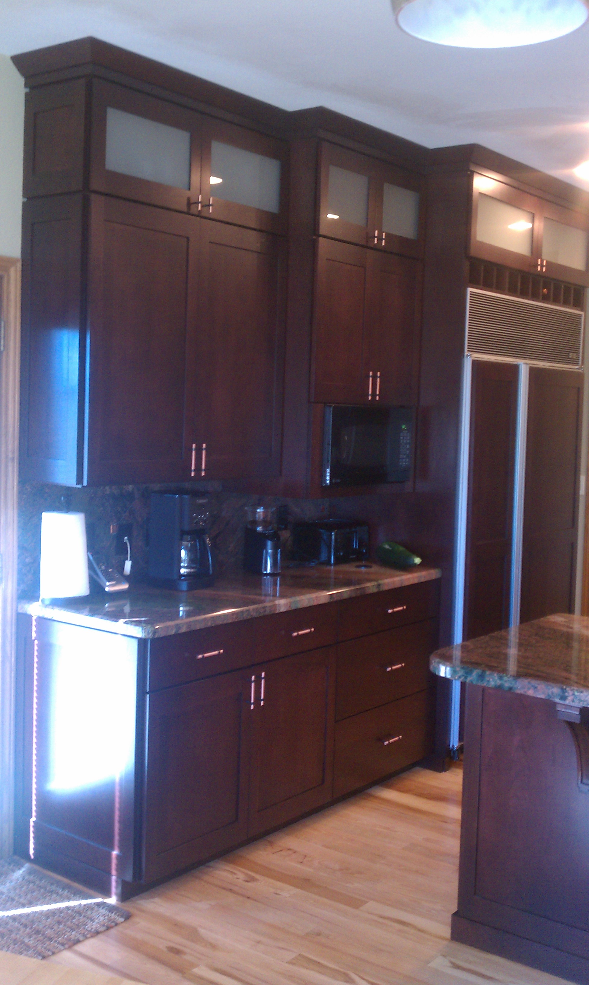 Shaker kitchen with frosted glass doors, full overlay spacing, crown moulding, full size base boards, and shaker side panels.