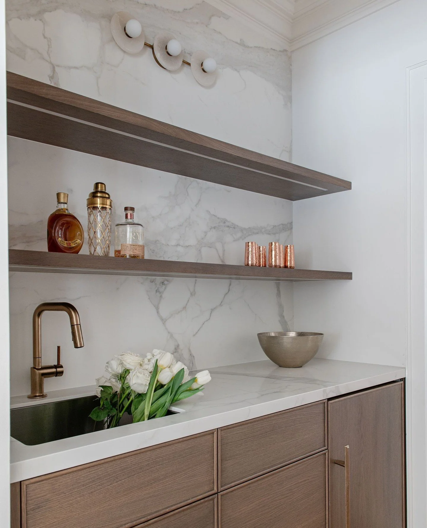 A pantry with purpose. Nestled between kitchen and dining room, this butler's pantry houses everything needed for mixed drinks, extra serving/glass/dishware for big events, a hidden bar fridge, drawers for kids to grab their own snacks (in floor to c