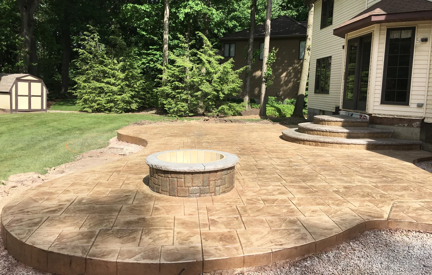 Large Ashlar Slate stamped patio, custom designed landing/steps along with matching 4 diameter fire pit. Thyme integral color w/ 70% Buff Tan & 30% Chestnut releases.