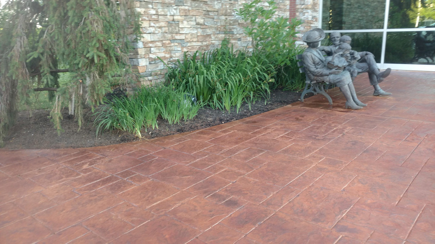 This photo is of a stamp restoration project. After years of sitting and lack of color; we were able to bring this office courtyard back to life, with Brickform Artesian water based stains. Gem seal was used to coat the canvas and really make the colors pop!