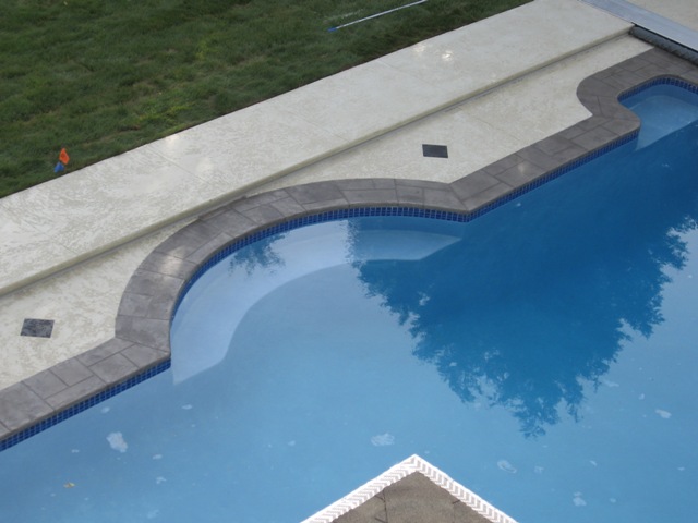 Decorative overlay (hand trowel and knockdown) around residential pool deck