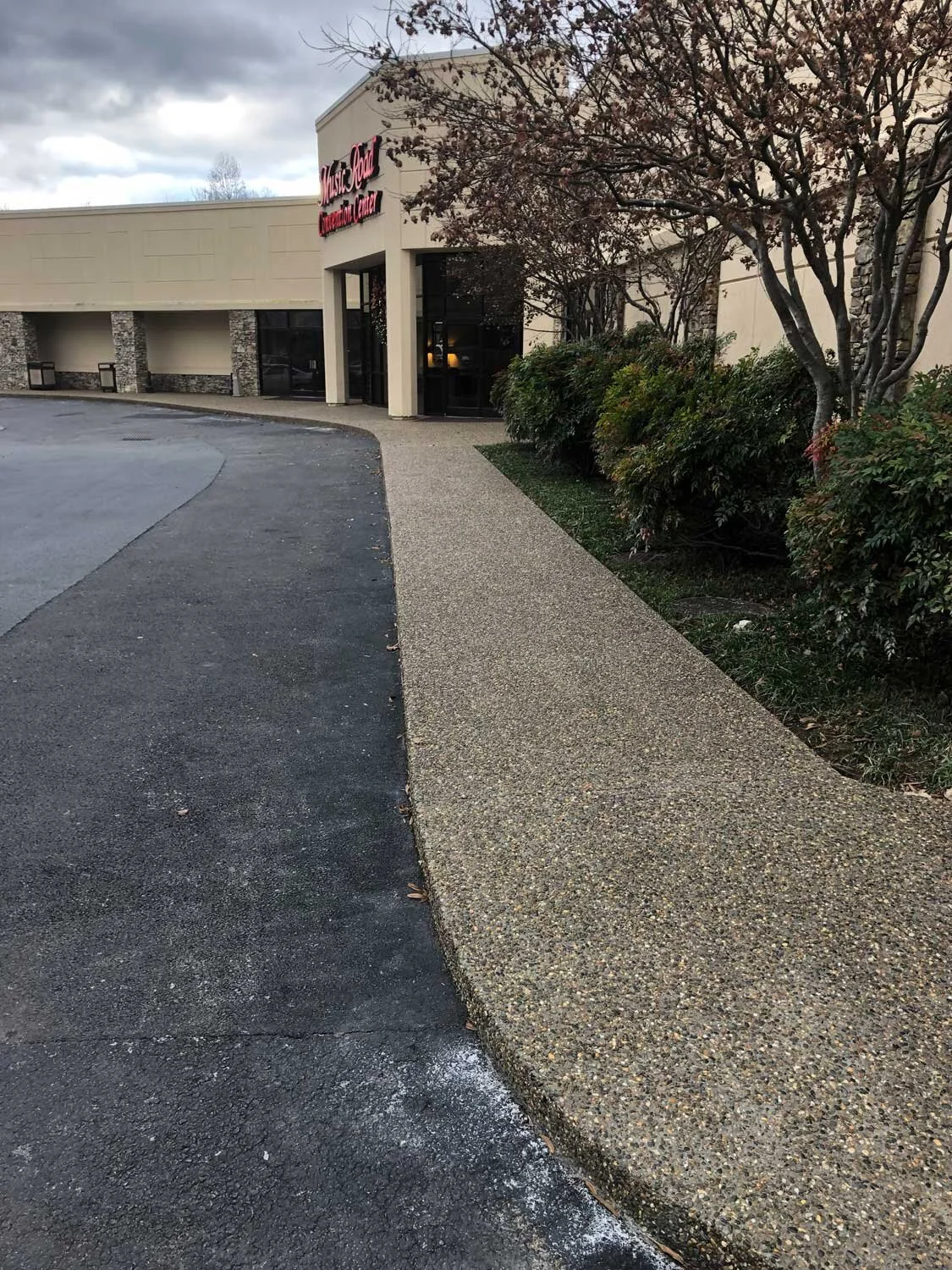 Exposed aggregate concrete featuring orange level surface deactivator.