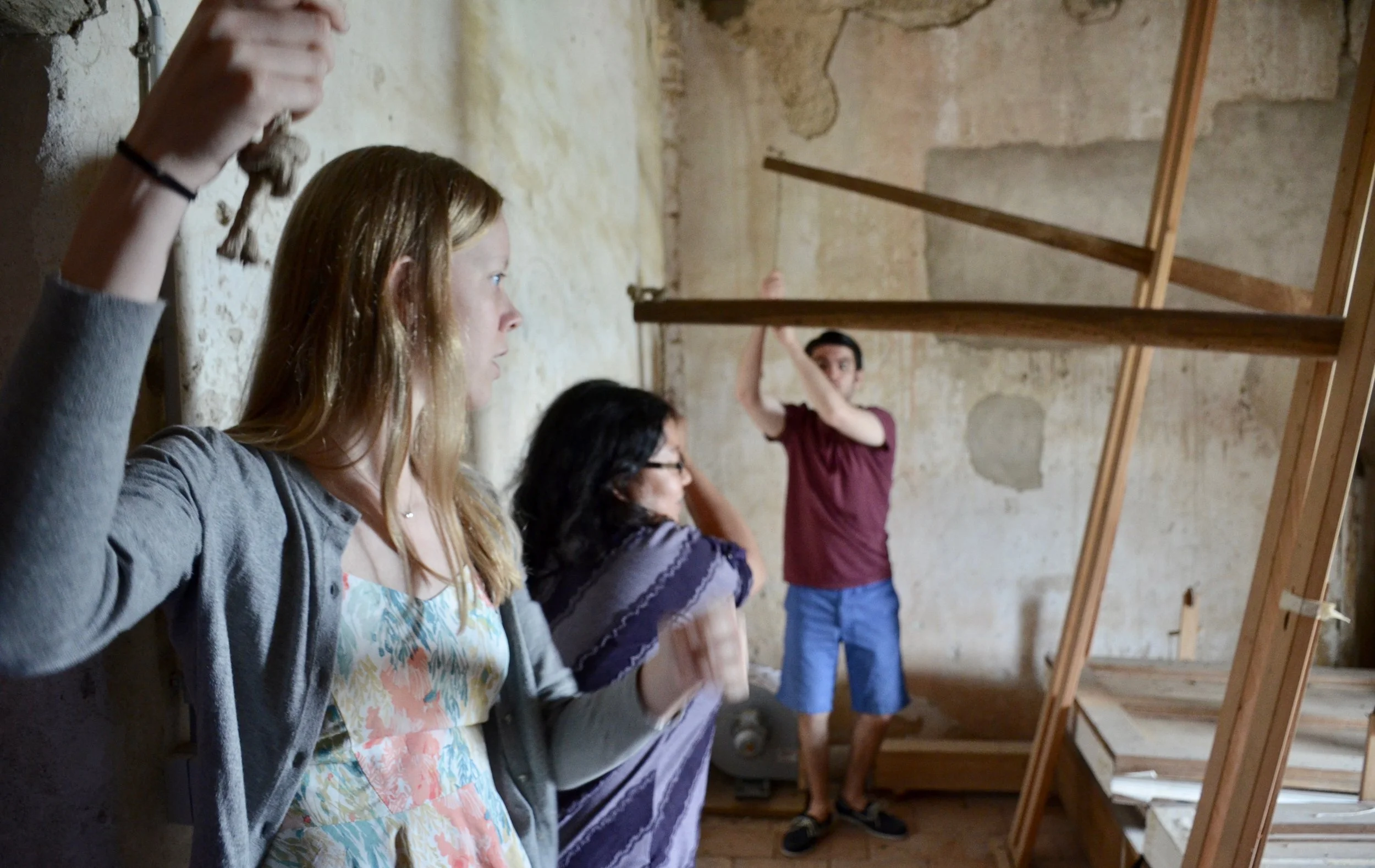 Laura Gullett, Jennifer Hsiao, and Brandon Santini pump the bellows of the French Classical instrument in St. Felix-Lauragais.
