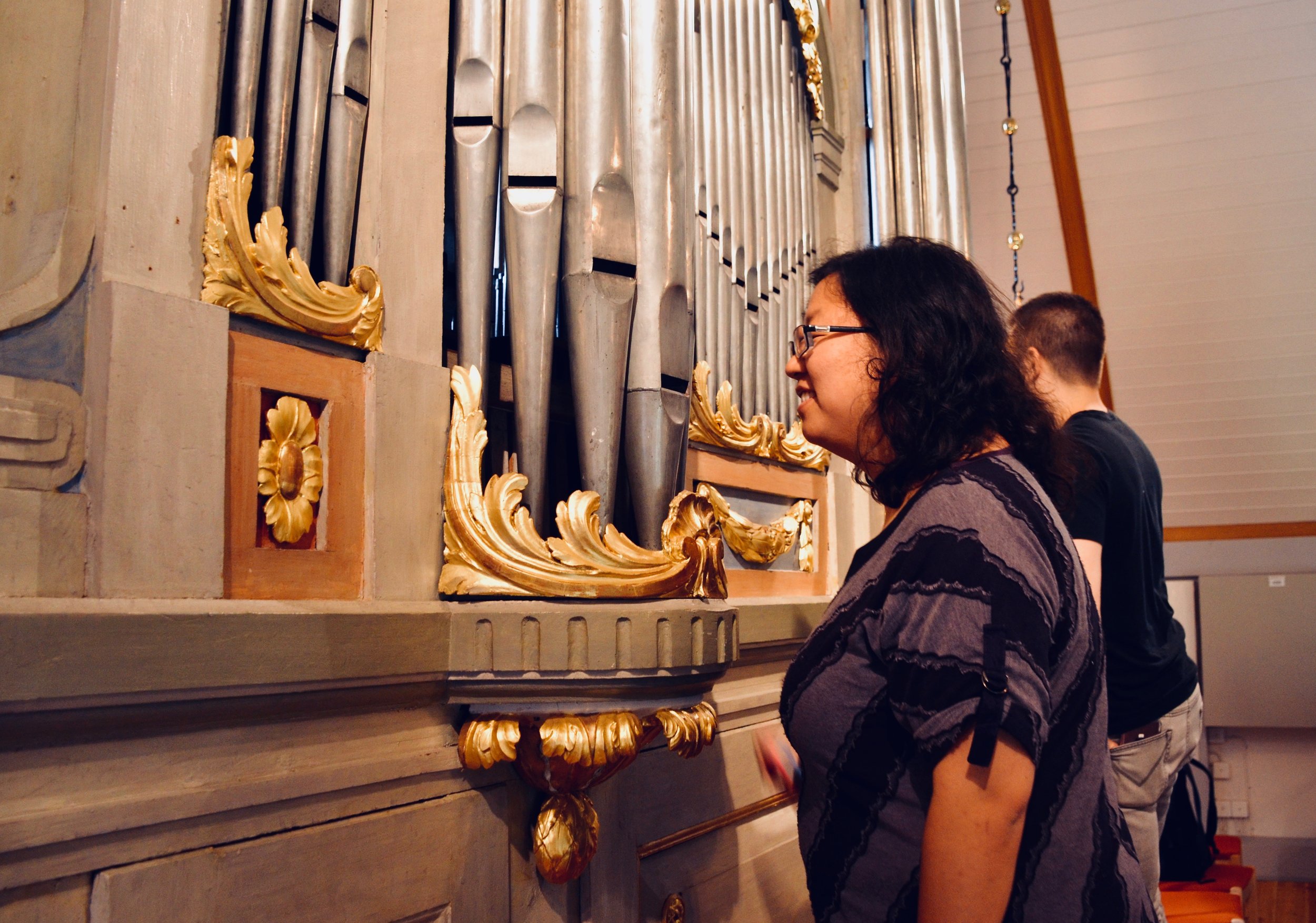Jennifer Hsiao examines the original pipework of the 1783 Schiörlin organ in Jonsered, Sweden. 