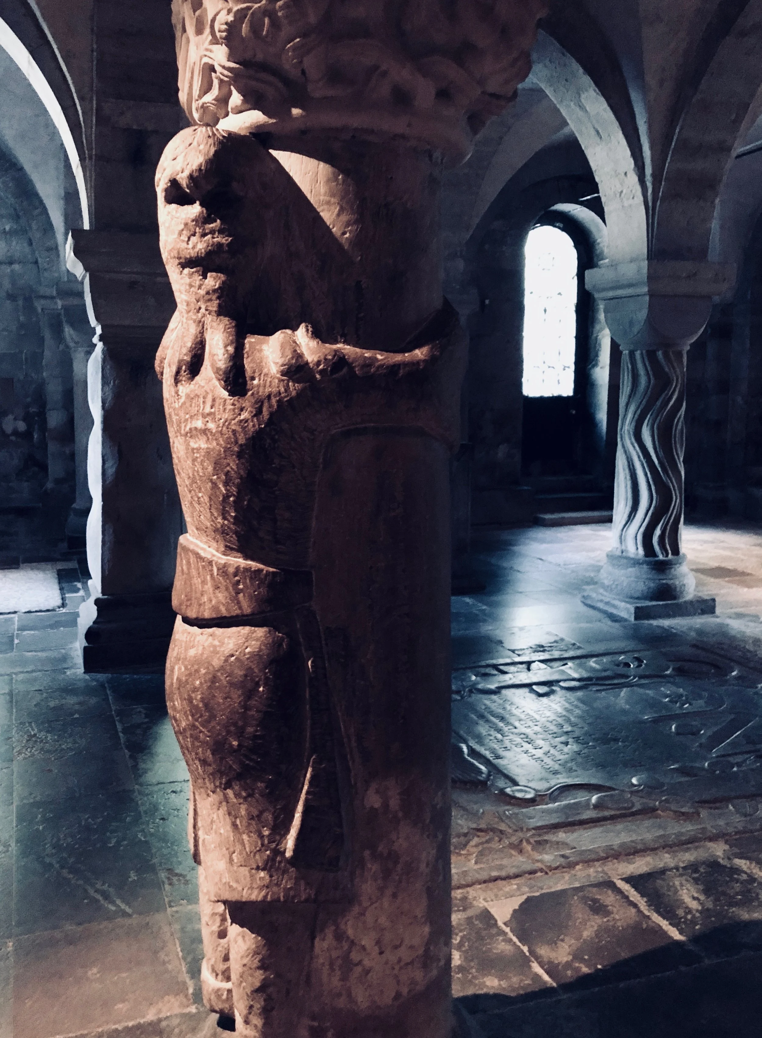 Finn, turned into stone, holding onto one of the stone columns in the crypt of Lund Cathedral. 