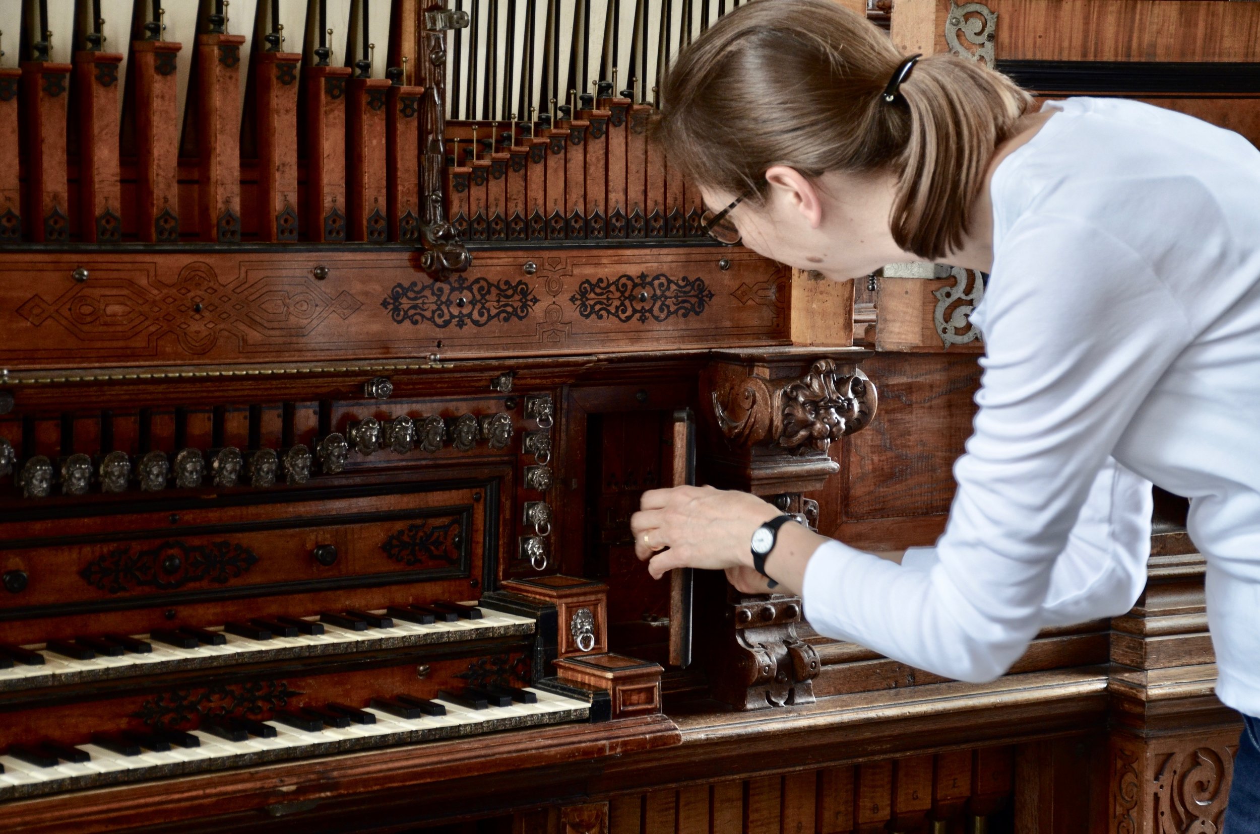 Castle organist Bine Bryndorf unlocks the 1610 Compenius organ, Frederiksborg Castle, Hillerød, Denmark.