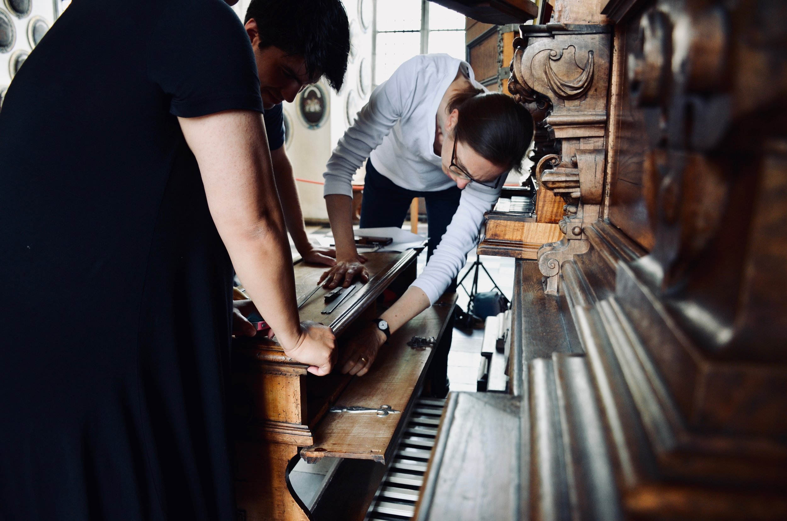Castle organist Bine Bryndorf opens the bench compartment, 1610 Compenius organ, Frederiksborg Castle, Hillerød, Denmark.