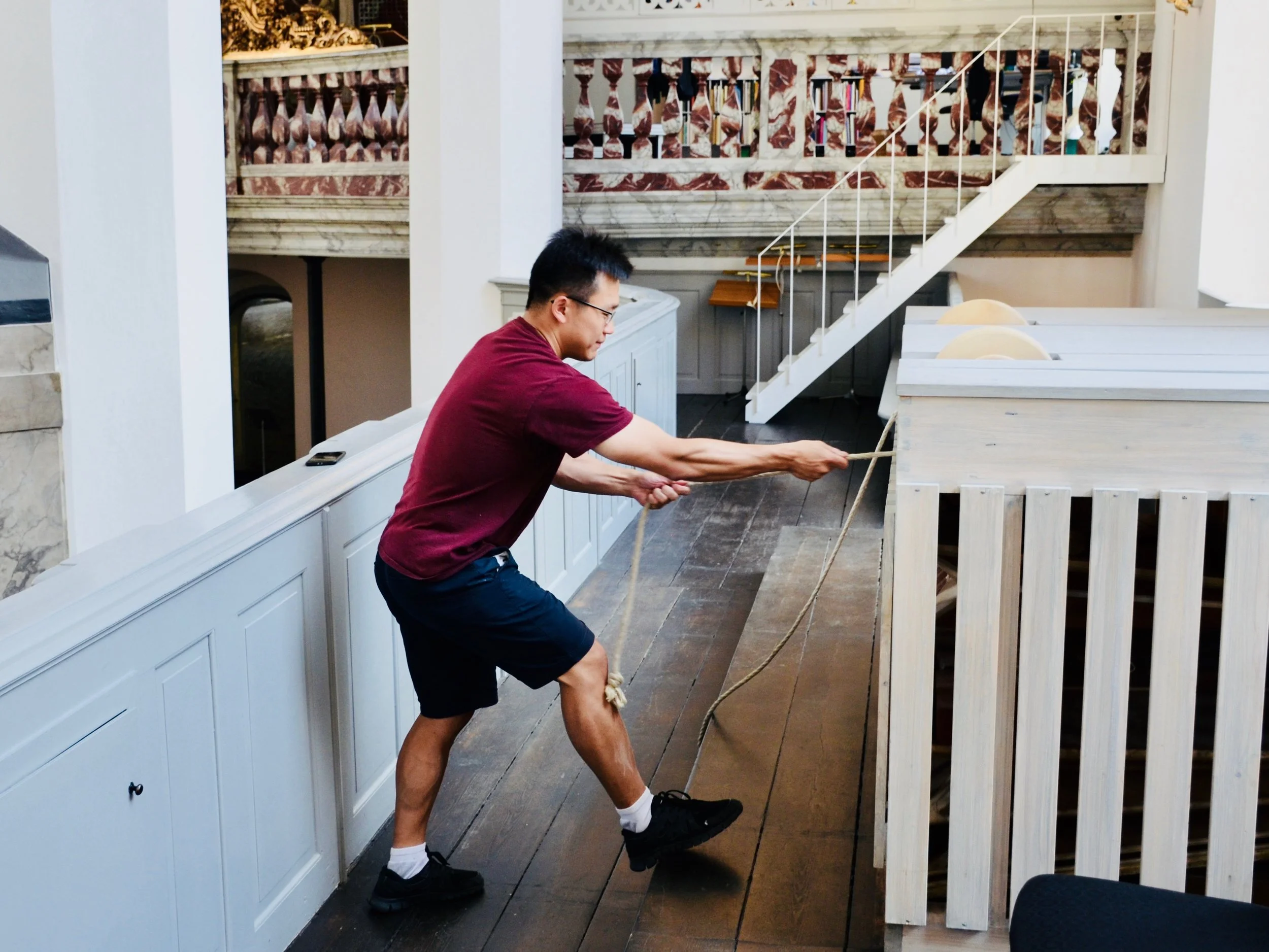 Adrian Cho pumps (pulls) the bellows of the Italian baroque organ in Trinitatis Kirke, Copenhagen. 