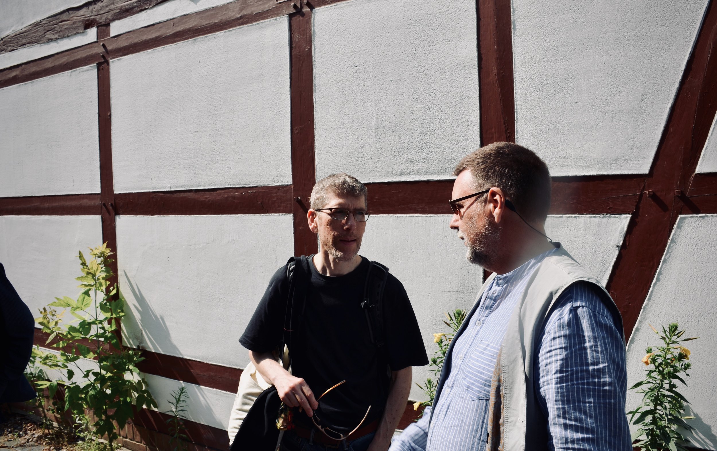 Chris Porter and Friedemann Lessing speak outside St. Nicolai-kirche, Osterburg.