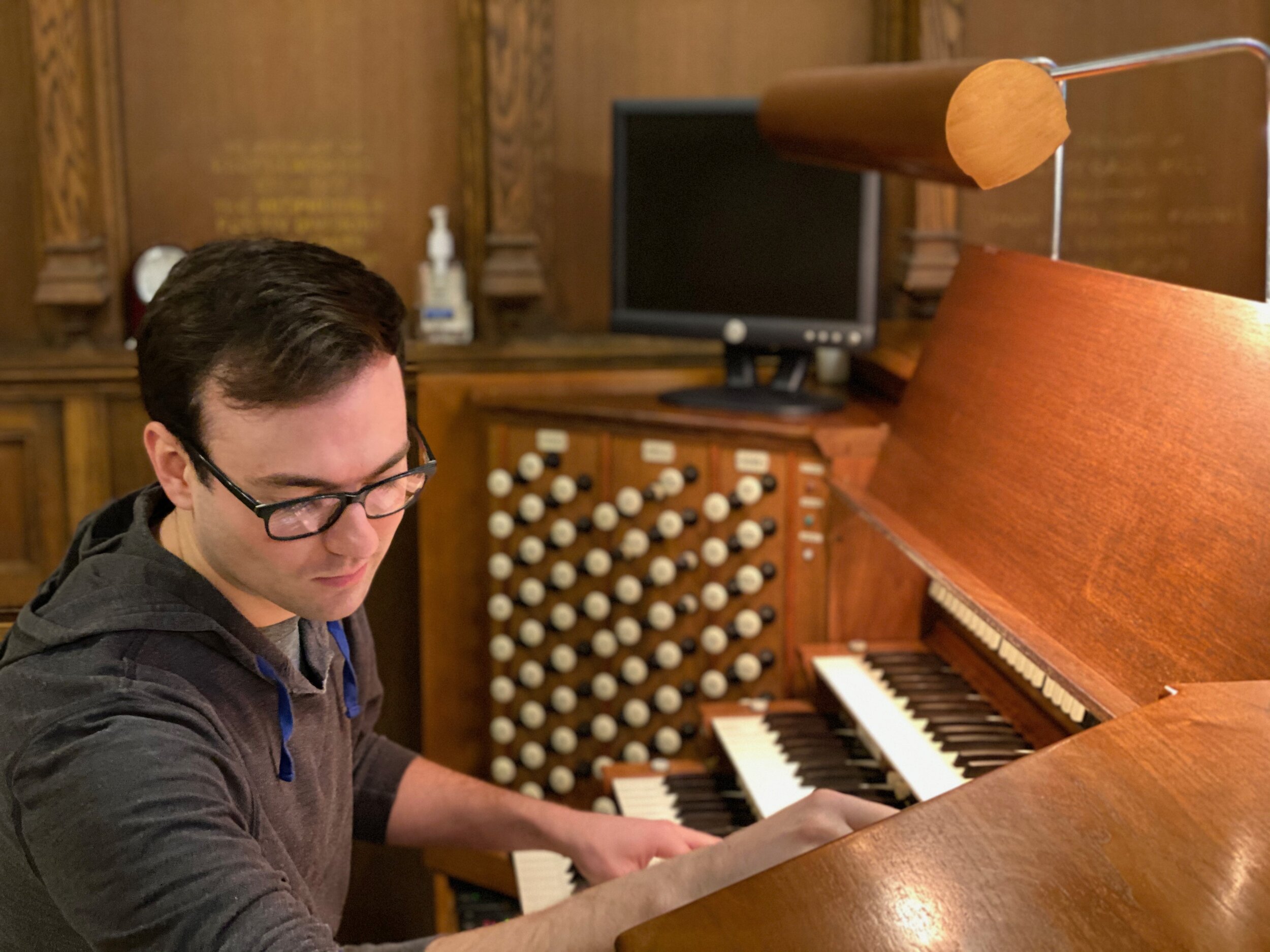 Kade Phillips at the console of the Aeolian-Skinner organ, All Saints Church, Worcester, Mass. 