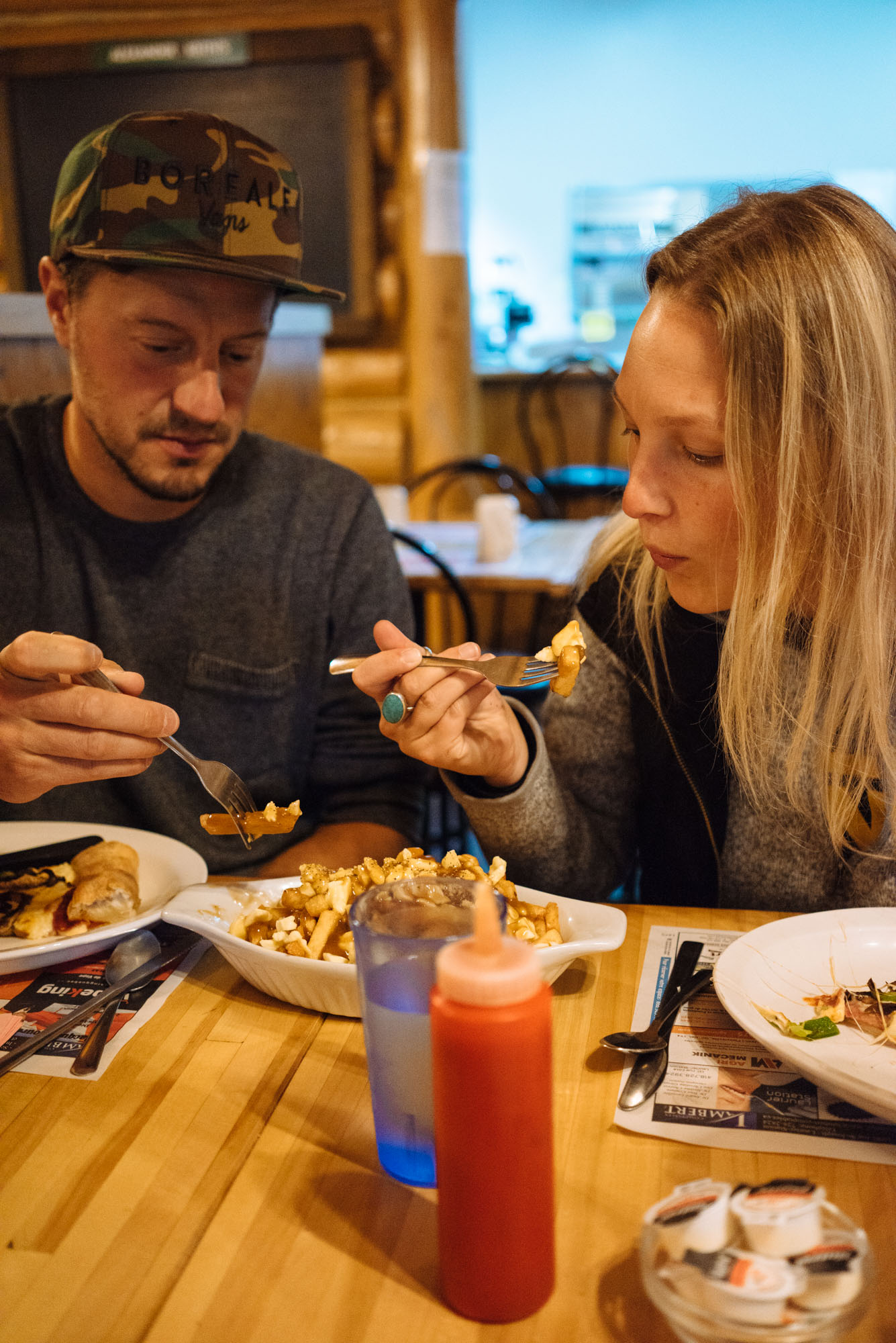 Katie and Julien enjoying… poutine!