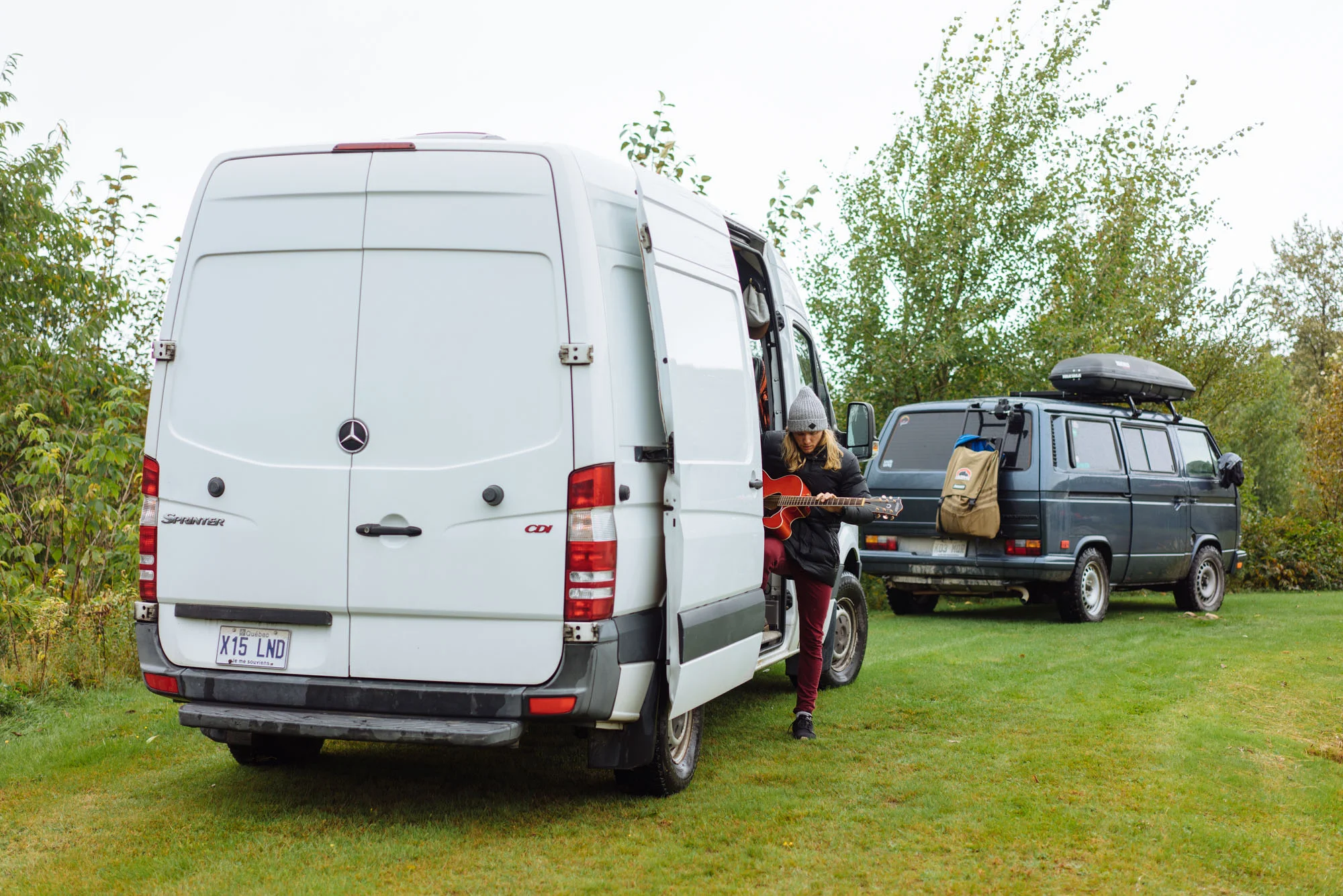 Anthony playing his guitar in his van