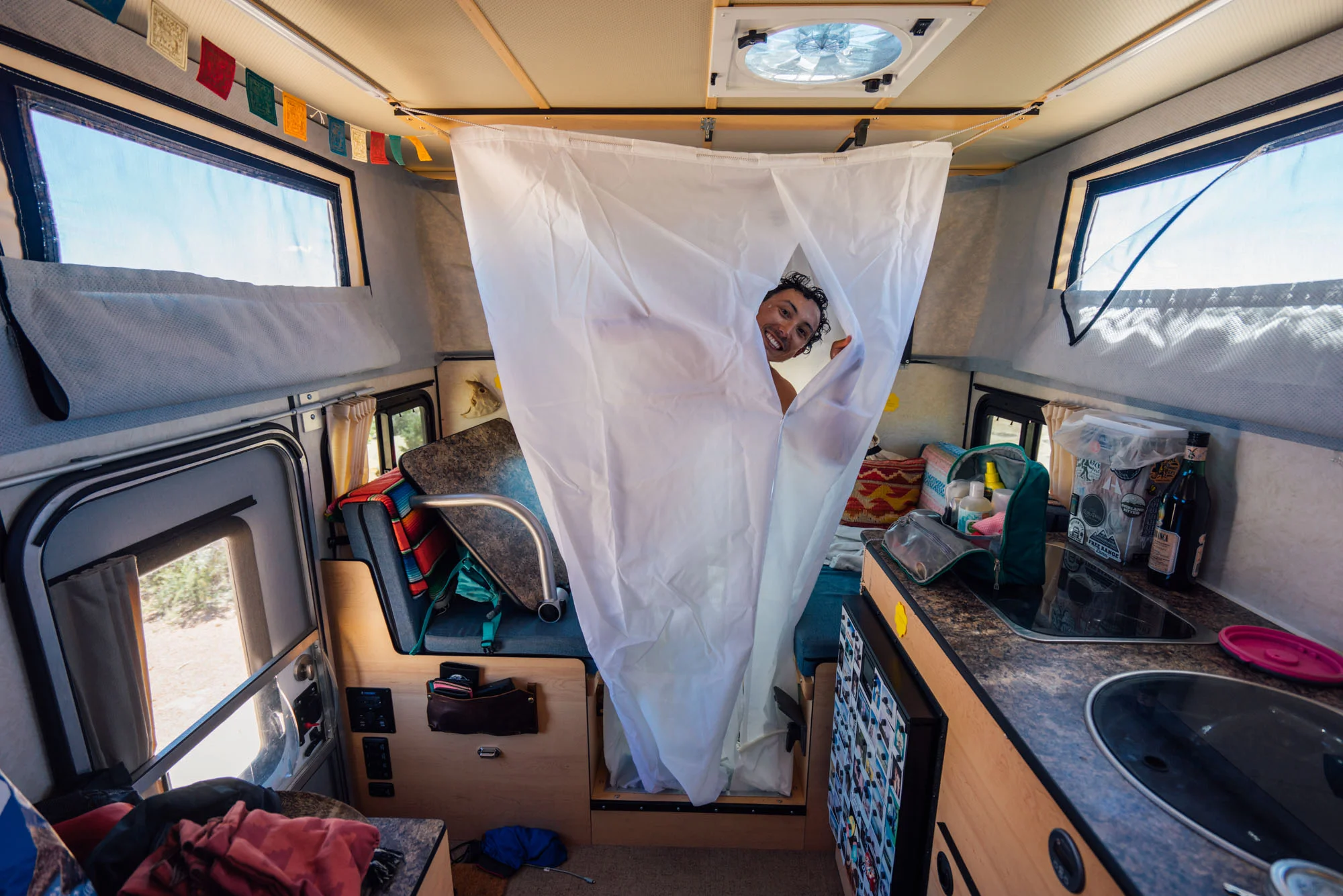 Owen using our indoor shower in the Four Wheel Camper