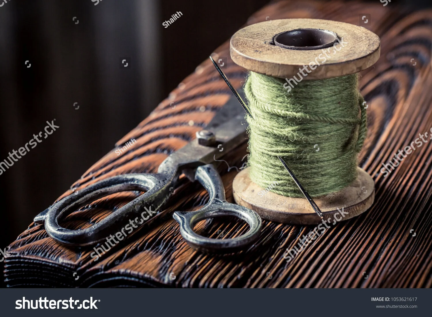 stock-photo-vintage-sewing-table-with-green-threads-and-scissors-1053621617.jpg