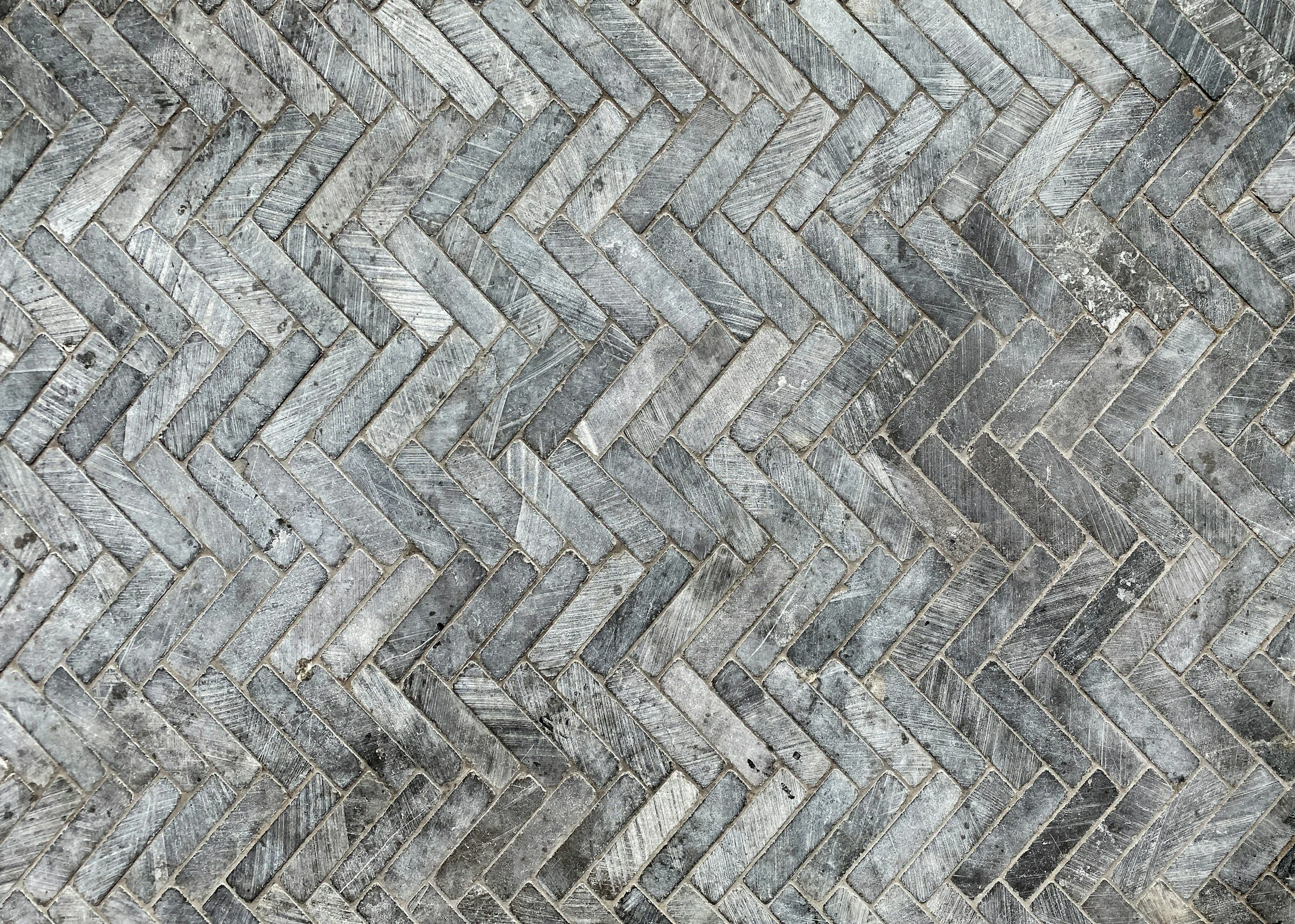 Grey marble tiles in a herringbone pattern
