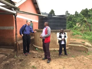 Dave Molzahn of Midland, MI confers with Alexander Gumoshabe, ACT’s Senior Manager about the water supply at the High School.