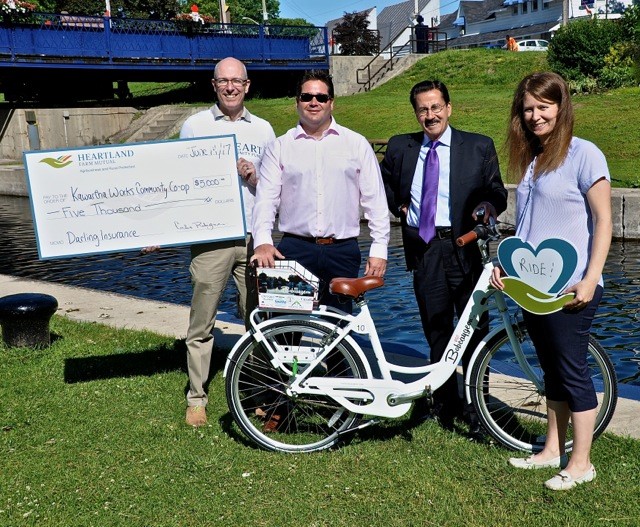 Photo by Bruce Hobley Larry Nickel VP Heartland Insurance Dave Kennedy Darling Insurance and Impact volunteer Carlos Rodrigues CEO Heartland Insurance Carly Poole Impact 32 founder