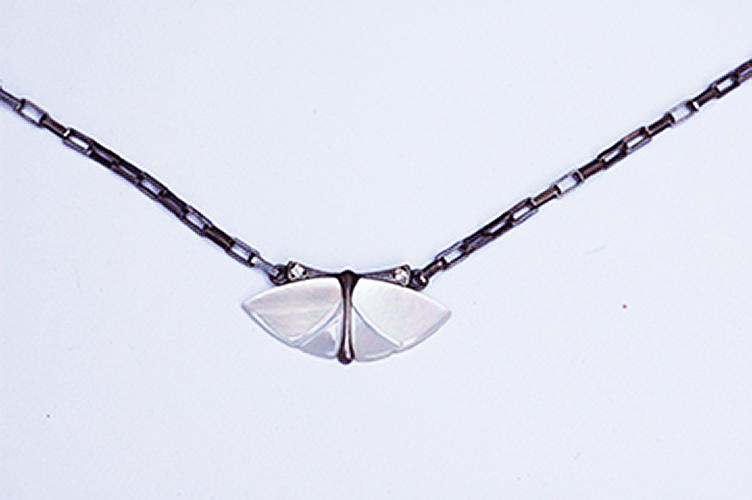 Sterling silver chain and body, blackened, mother of pearl wings, white diamonds on the antenna