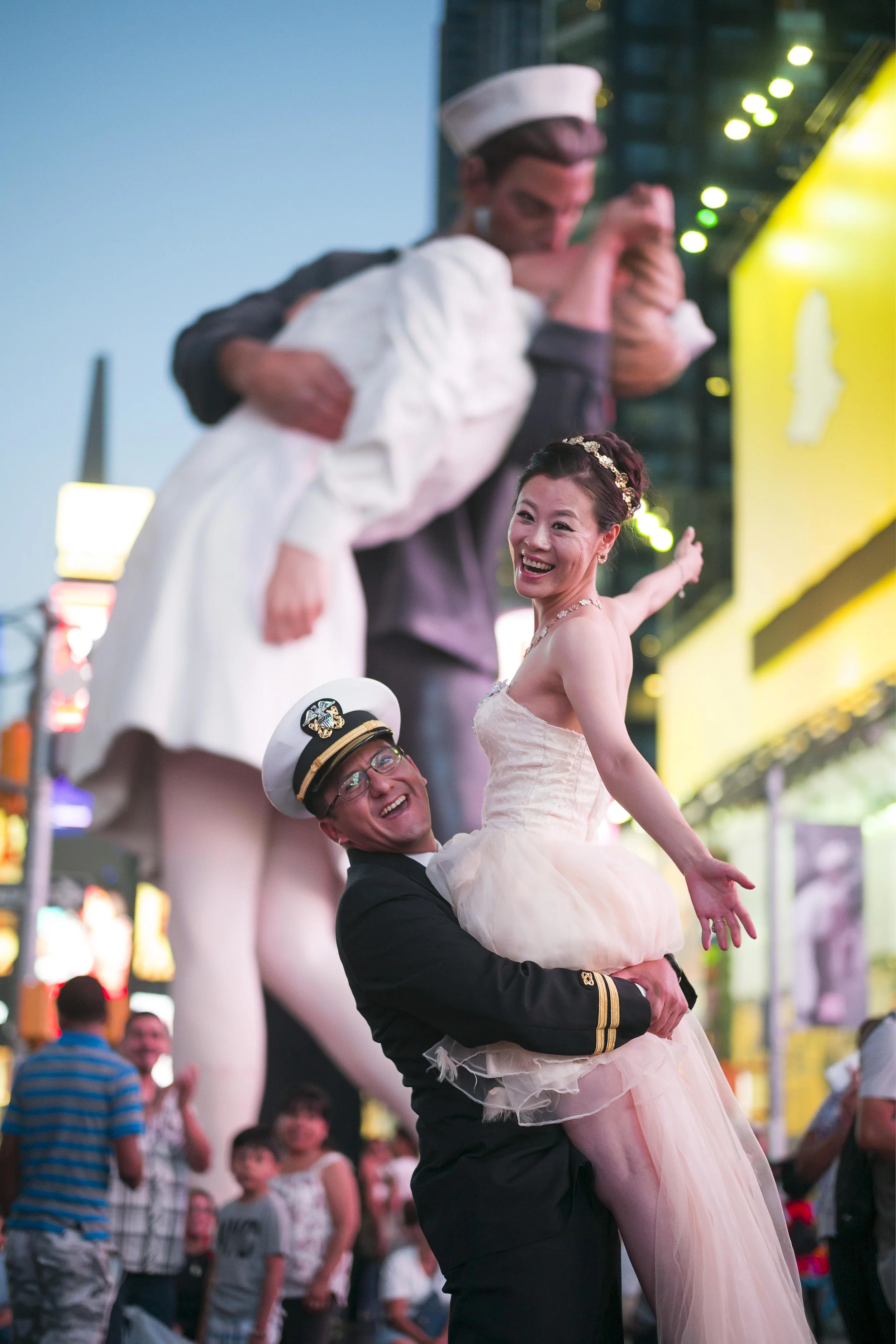 Bride and Groom pose together in times square New York City. Westchester Wedding Photographer