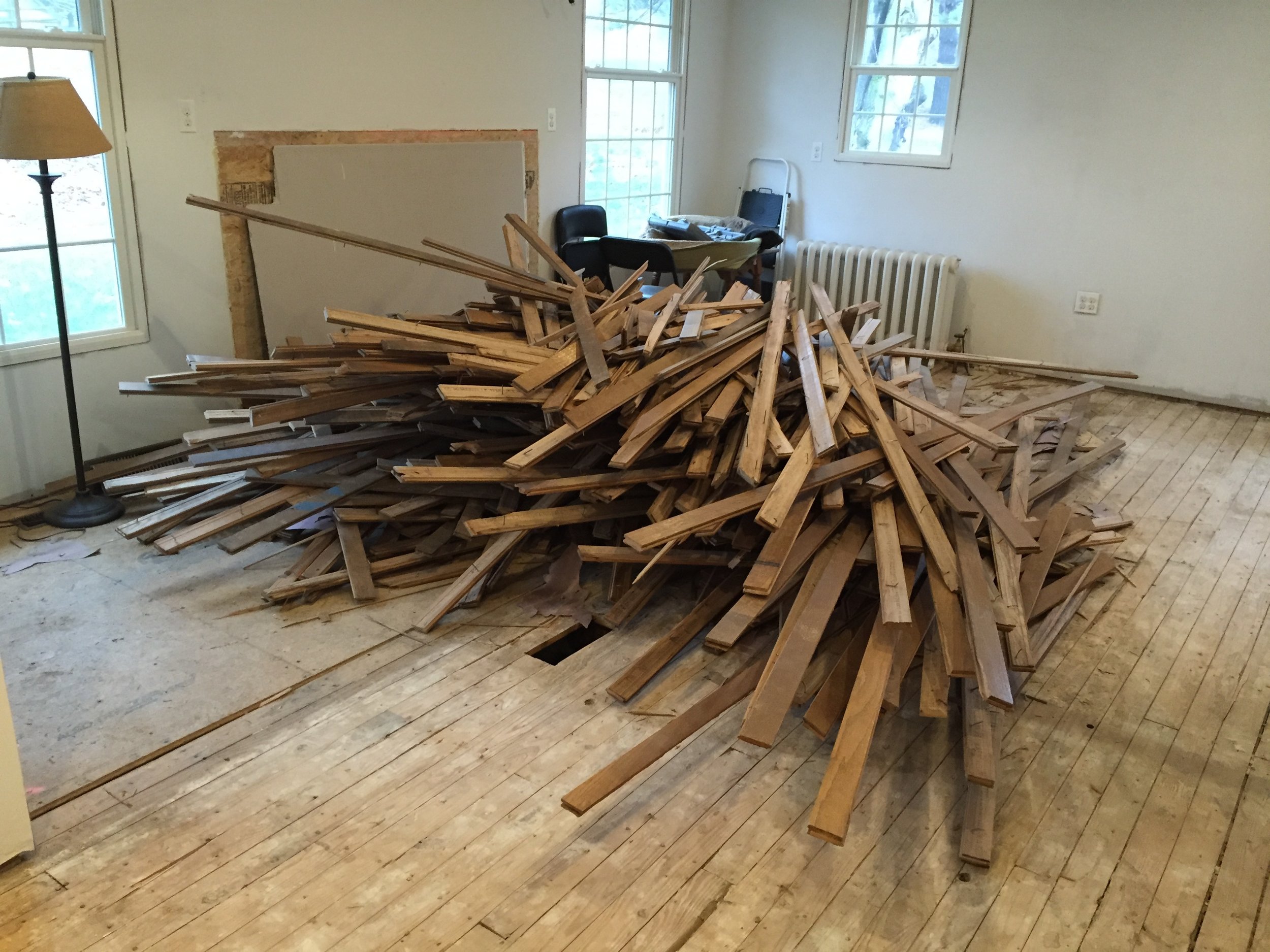  While  my own house  was under construction I lived with a mish-mash of old oak floors, plywood patches, and ancient linoleum for a few years before I was ready to install new floors. Here you can see the old oak flooring piled up after demolition.&