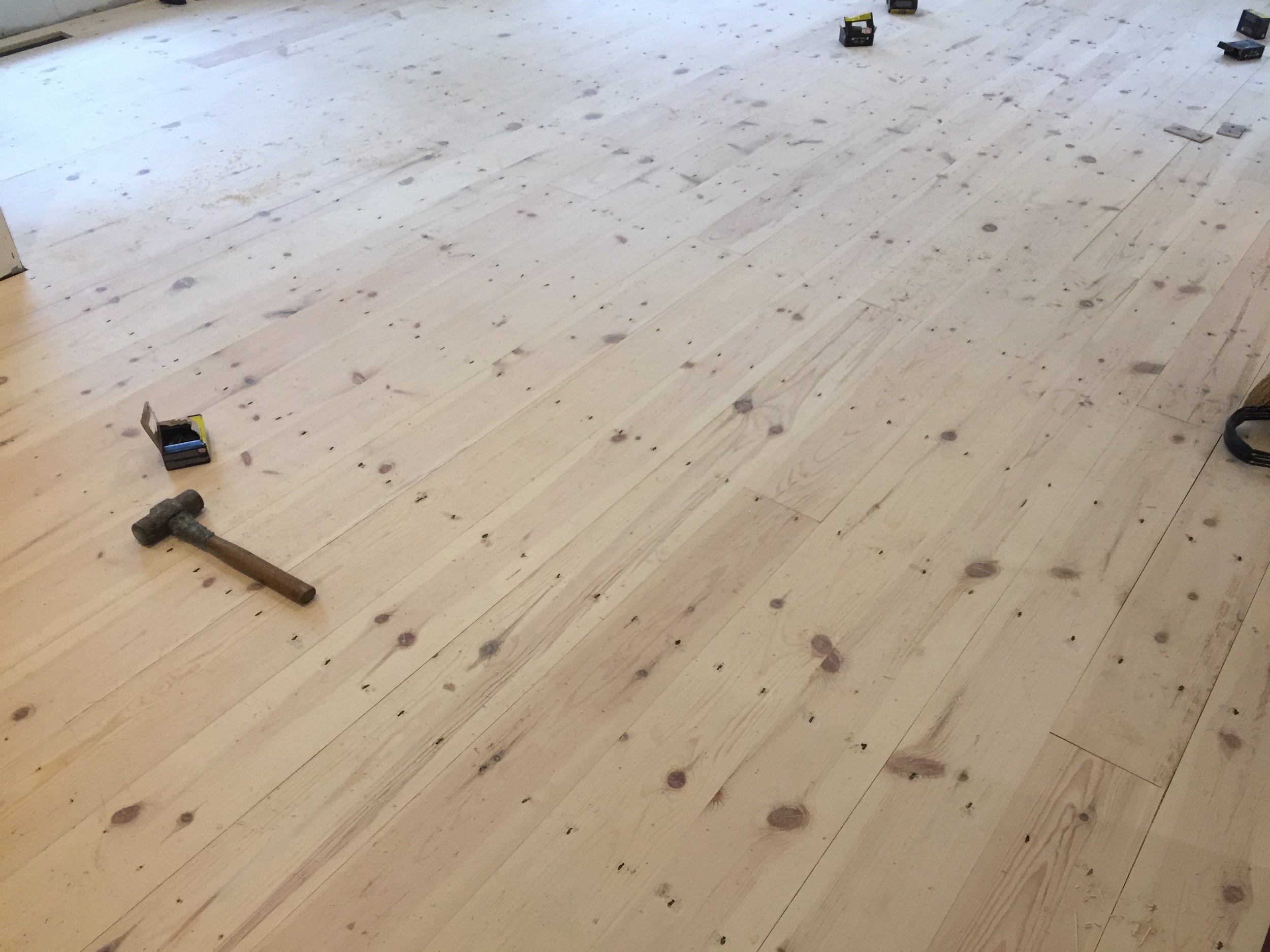  To get the antique look we wanted, I hammered in masonry cut nails through the face of the planks.&nbsp;It ended up being 2,420 nails (63 lbs worth). It'll be a few years until I forget how bad it was and agree to put new floors in upstairs. 