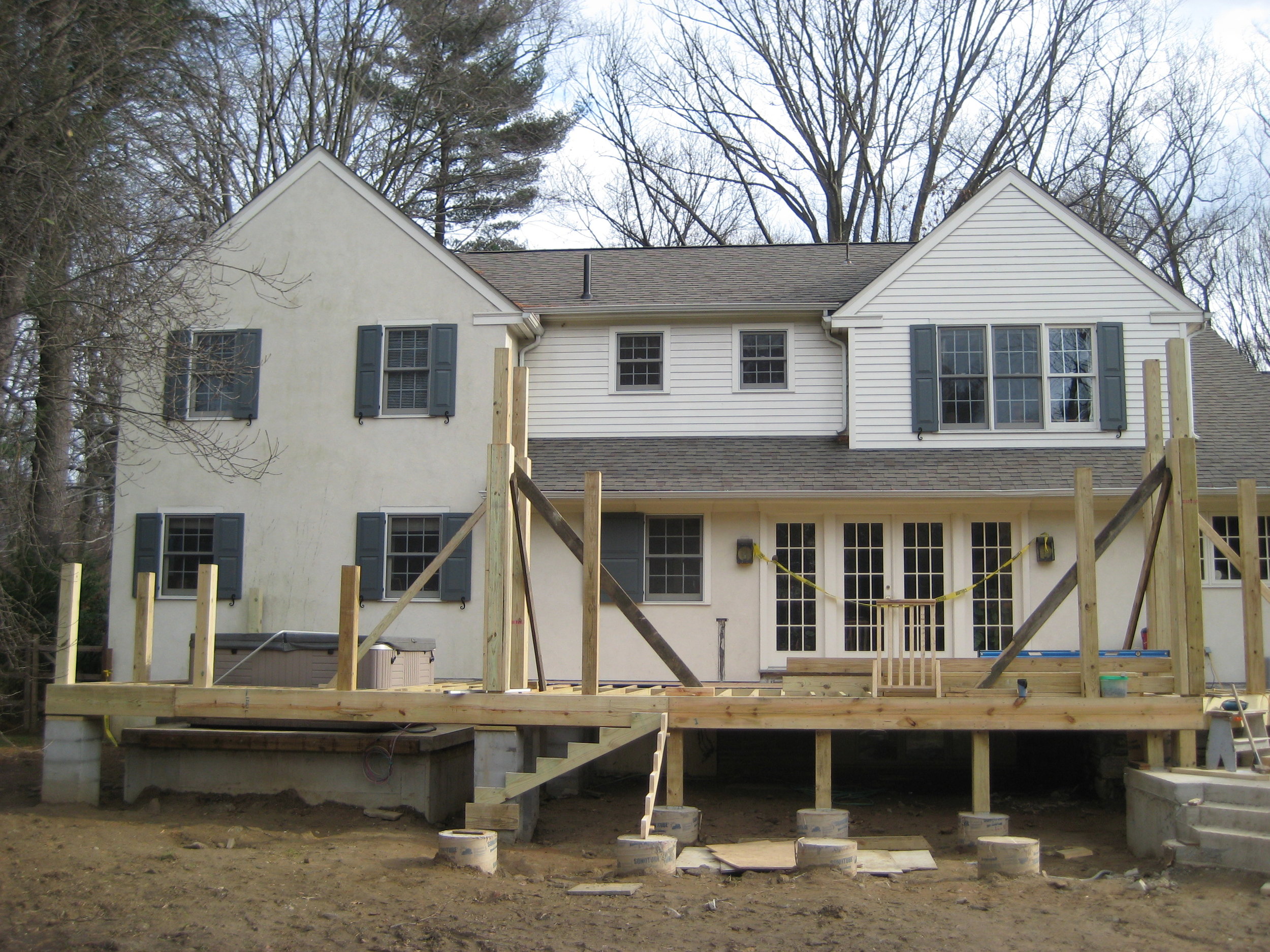  We installed new footings and a pad to elevate the original hot tub up into the new deck. Then we began to install the framing.&nbsp; 