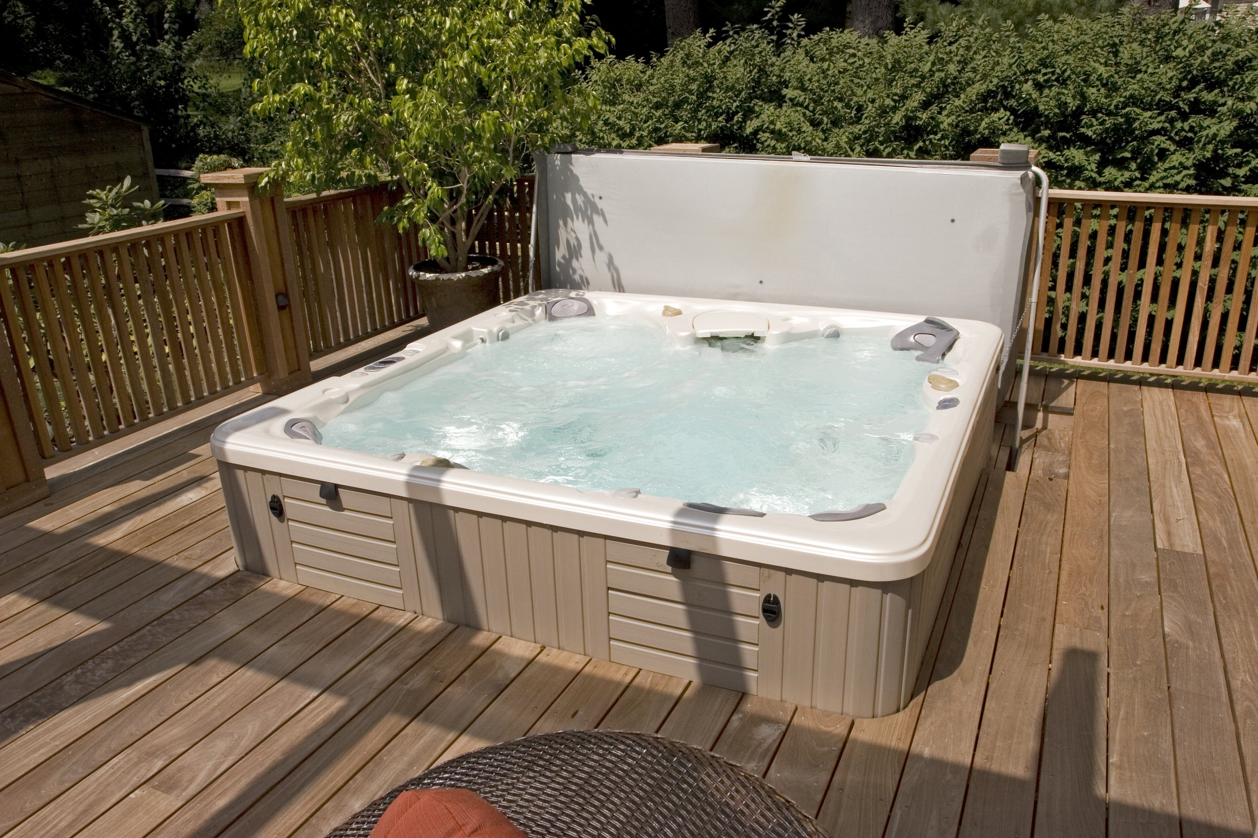  The hot tub surrounded by the new decking. The tub sits up above the decking approximately 20" so that it's easy to sit on and turn to drop right in.&nbsp; 