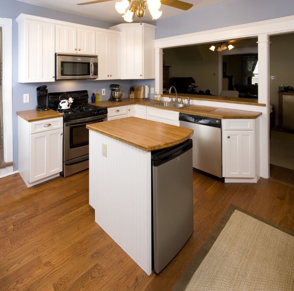  Wide angle shot of the new kitchen, showing the wine fridge in center island. We opened the wall up between the kitchen and dining room to allow for more light, better airflow, and to create a breakfast bar for casual dining.&nbsp; 