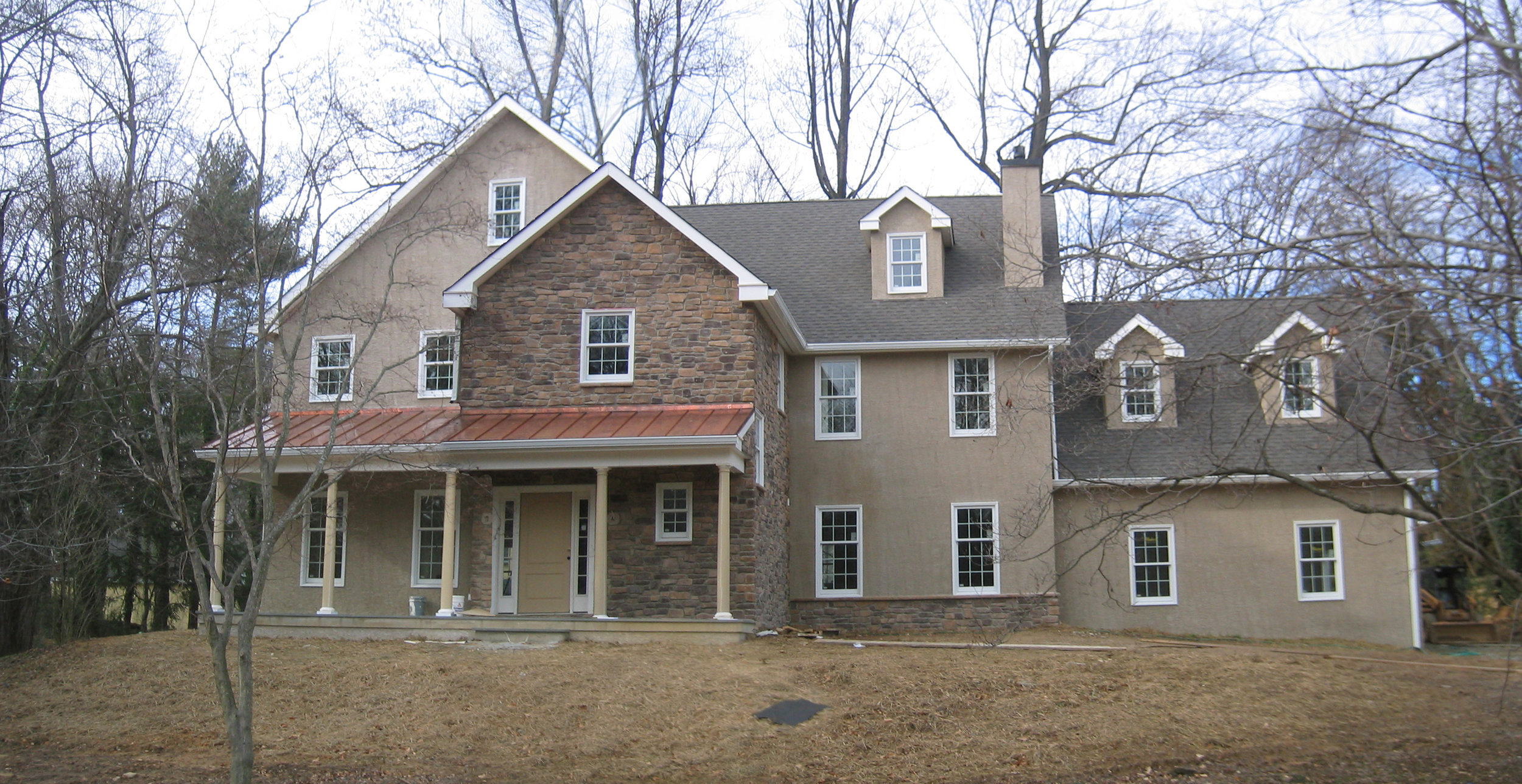  This is a custom house we built in 2007. While the photogragh is a little drab because it was winter, it's the only time of year to see the whole house because the leaves are off the trees. 