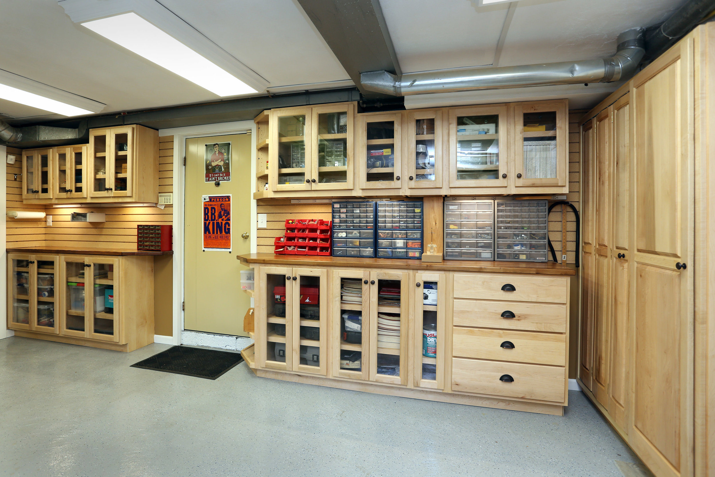  I designed and built these custom maple cabinets with plexiglass door panels to allow the client to see the items stored within. The floor was painted with a epoxy based garage floor paint to create an easily cleaned and stain resistant surface. 