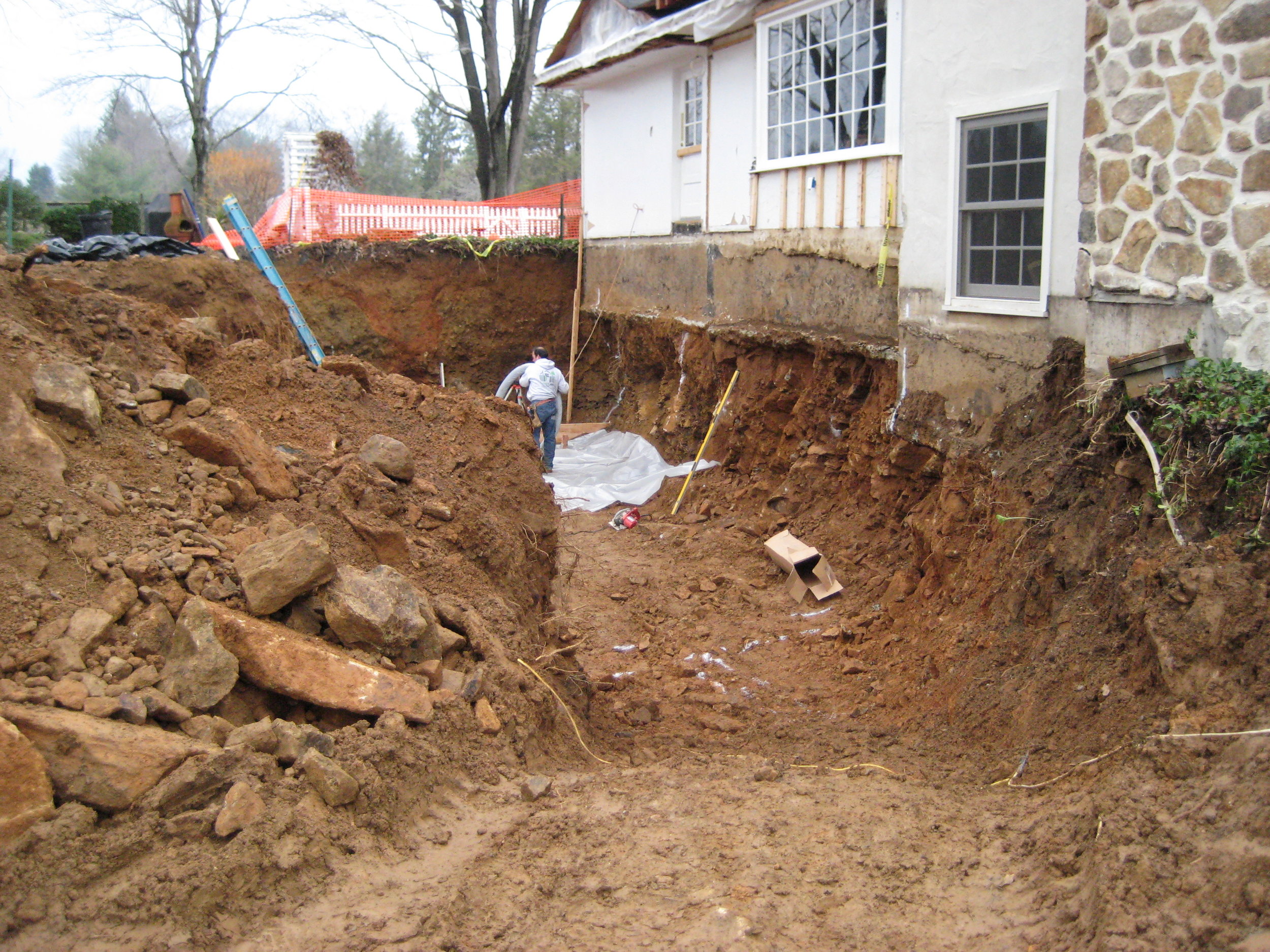  The original house didn't have a full basement, but the new addition would. This required us to excavate below the foundation of the main house. 