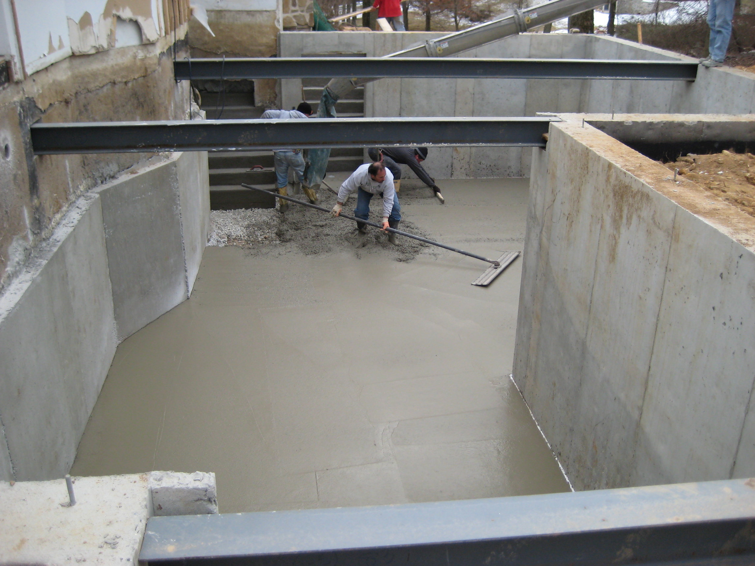  Basement floor going in;&nbsp;the finished underpinning wall is on the left. 