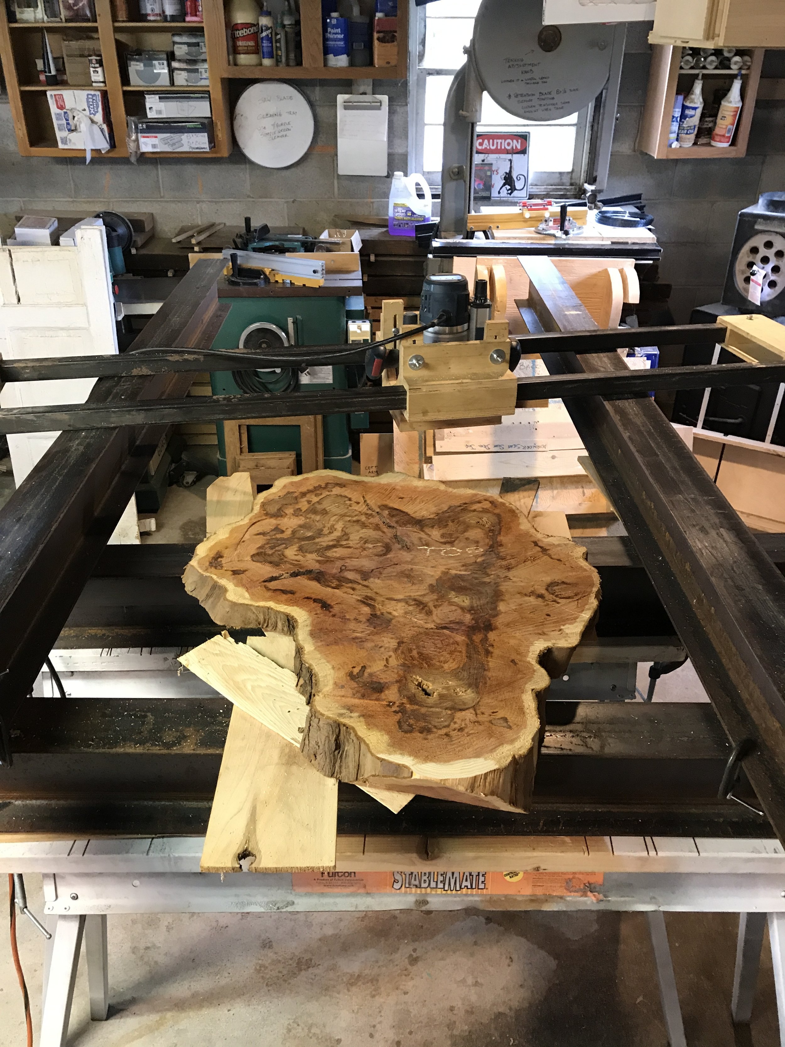  A client had a large yew bush cut down on their property and brought me a slab from the stump to use for an outdoor table. Since it was freshly cut, it had to dry for a year or so on my racks before it was ready for use. After it had dried, I put it