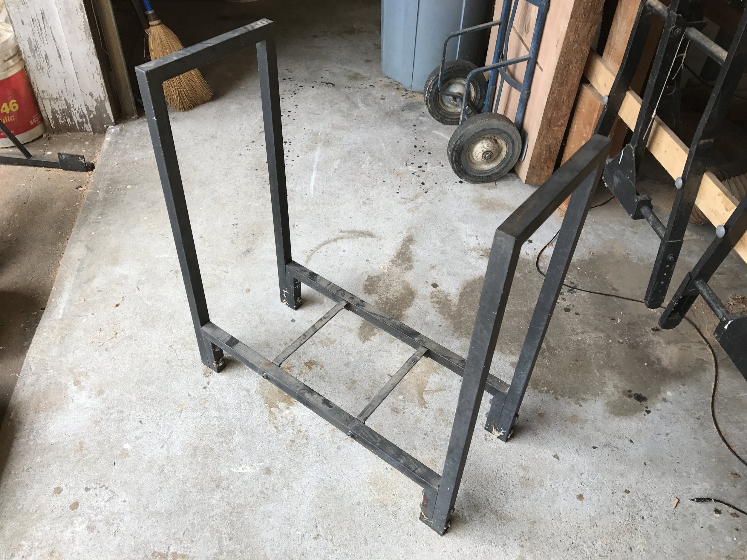  A client came to me with an old firewood holder they wanted to repurpose for an outdoor table. She chose some old barn beams I had in the shop to make up the table top and lower shelf.&nbsp; 