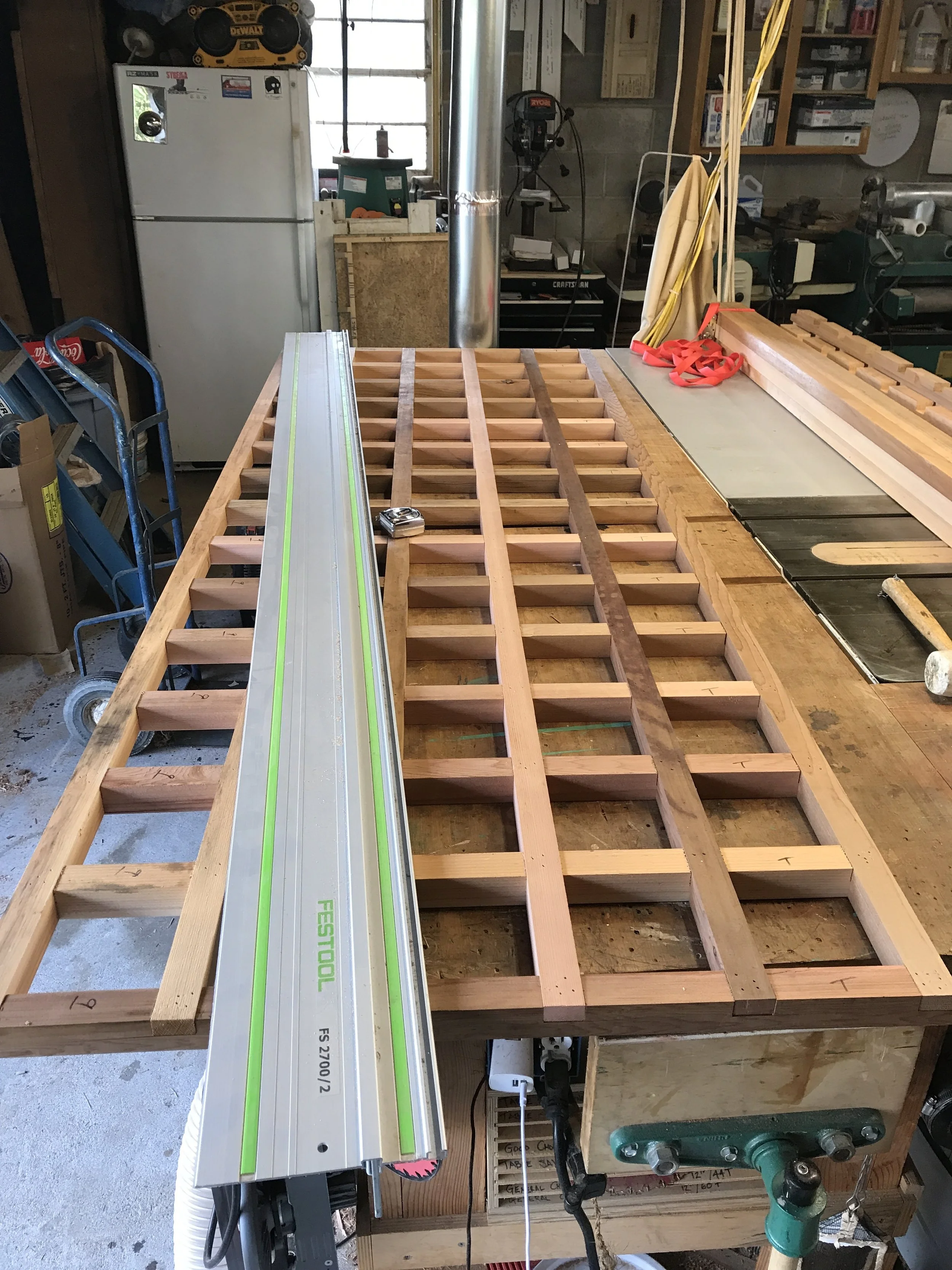  I assembled the grids taller than they needed to be and then trimmed the bottom off to match the grade of the property. We took elevations on the property at the locations for each panel and used this information to calculate the necessary angle for