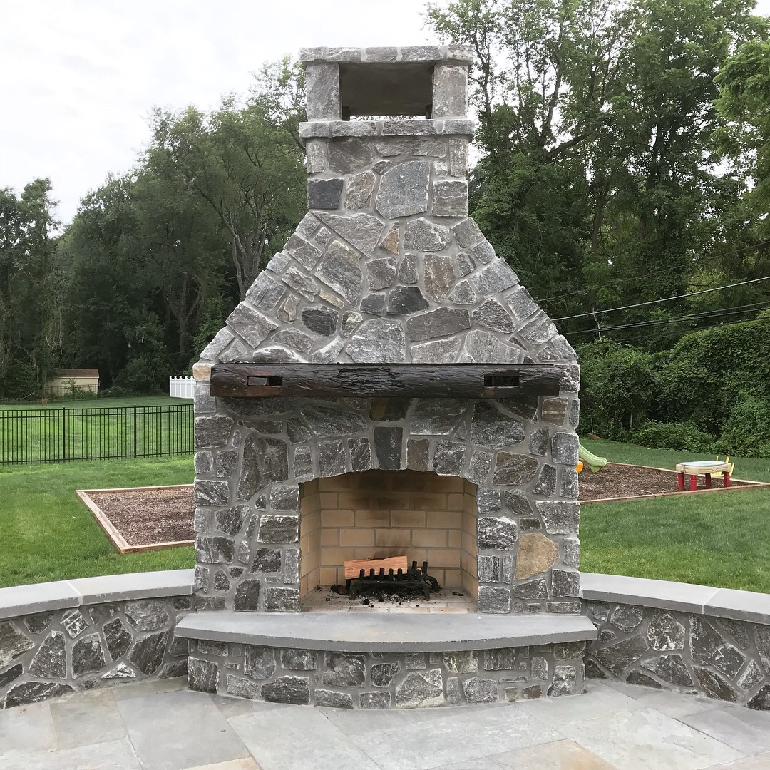  A wider shot of the outdoor fireplace and mantle. The fireplace, patio, retaining walls, and all stonework were built by Doyle &amp; McDonnell, Inc of Berwyn, PA.  